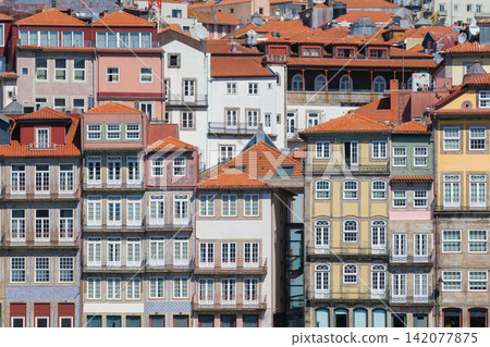 Ribeira houses in Porto, Portugal, a UNESCO World Heritage Site, with sunny walls, terracotta rooftops and traditional windows in Porto Ribeira Ribeira houses in Porto, Portugal, a UNESCO World Heritage Site, with sunny walls, terracotta rooftops and traditional windows in Porto Ribeira 142077875