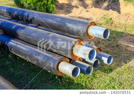 Insulated Pre-isolated Steel Pipes Stacked Outdoor at Utilities Insulated Pre-isolated Steel Pipes Stacked Outdoor at Utilities 142078531