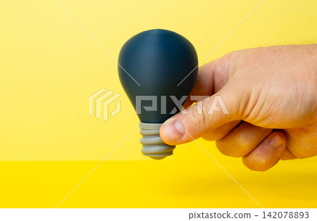 The switched off light bulb is an idea in the hand. Startup incubator. Spark inspiration. Idea generation concept, innovation search and early stage creativity before launch The switched off light bulb is an idea in the hand. Startup incubator. Spark inspiration. Idea generation concept, innovation search and early stage creativity before launch 142078893