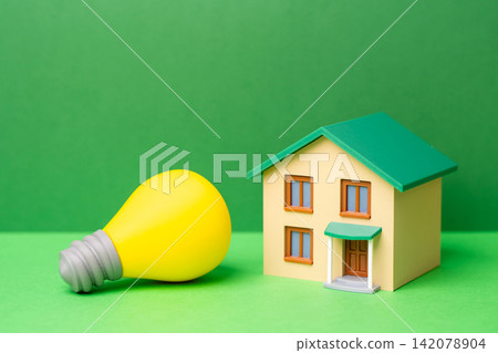 A house and a yellow light bulb. Electricity and autonomy. Energy efficient living, connected home systems and backup power solutions. Digital comfort, smart technology A house and a yellow light bulb. Electricity and autonomy. Energy efficient living, connected home systems and backup power solutions. Digital comfort, smart technology 142078904