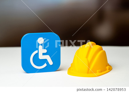 A symbol of a person with a disability and a construction hardhat. Construction of barrier-free urban space and infrastructure. Reimagining the urban environment for people with disabilities. A symbol of a person with a disability and a construction hardhat. Construction of barrier-free urban space and infrastructure. Reimagining the urban environment for people with disabilities. 142078953