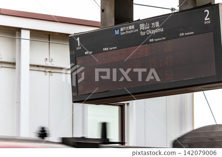 車站月台上的航班資訊顯示器和駛過的列車照片。 車站月台上的航班資訊顯示器和駛過的列車照片。 142079006