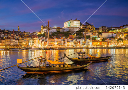 Night Porto rabelo boats on Douro River by Ribeira, Portugal quayside view Night Porto rabelo boats on Douro River by Ribeira, Portugal quayside view 142079143