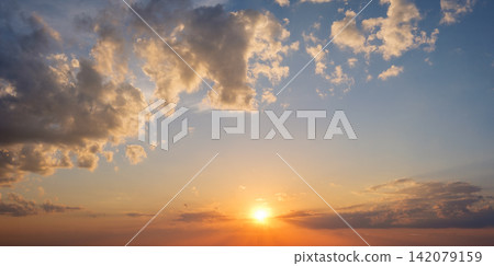 Breathtaking sunset with dramatic clouds in a colorful sky Breathtaking sunset with dramatic clouds in a colorful sky 142079159