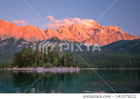 Close up of Maximiliansinsel island at Eibsee lake during sunset glow Close up of Maximiliansinsel island at Eibsee lake during sunset glow 142079222