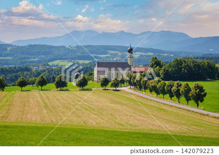 Irschenberg pilgrimage church Wilparting under cloudy sky in Bavaria Germany Irschenberg pilgrimage church Wilparting under cloudy sky in Bavaria Germany 142079223