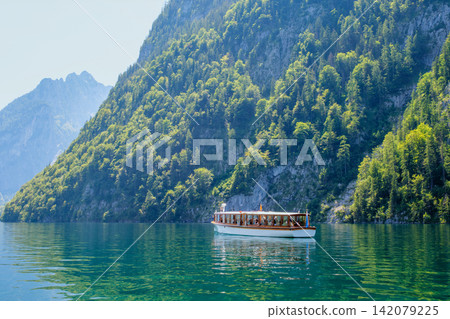 Traditional wooden boat on Konigssee lake in Bavaria Germany mountain peak Traditional wooden boat on Konigssee lake in Bavaria Germany mountain peak 142079225