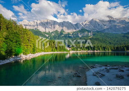 Eibsee lake shore with Zugspitze mountain and pine trees in Bavaria Germany Eibsee lake shore with Zugspitze mountain and pine trees in Bavaria Germany 142079275