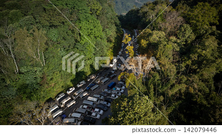 Mountain parking lot surrounded by dense forest at Doi Tung, Chiang Rai, serving visitors to Phra That Doi Tung in 2023. Mountain parking lot surrounded by dense forest at Doi Tung, Chiang Rai, serving visitors to Phra That Doi Tung in 2023. 142079446