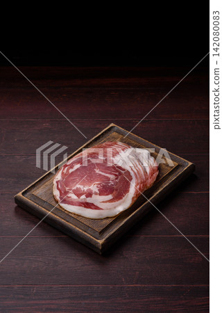 Slices of pork pancetta, ham, or bacon for a festive antipasto platter Slices of pork pancetta, ham, or bacon for a festive antipasto platter 142080083