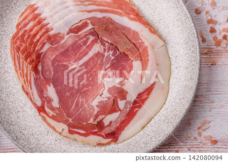 Slices of pork pancetta, ham, or bacon for a festive antipasto platter Slices of pork pancetta, ham, or bacon for a festive antipasto platter 142080094