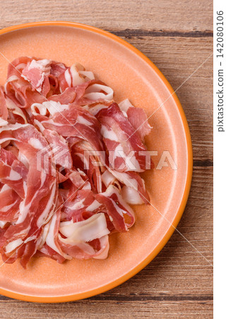 Slices of pork pancetta, ham, or bacon for a festive antipasto platter Slices of pork pancetta, ham, or bacon for a festive antipasto platter 142080106
