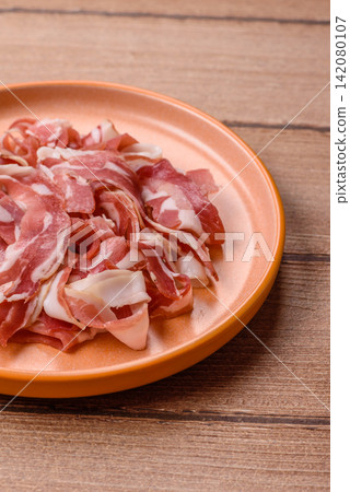 Slices of pork pancetta, ham, or bacon for a festive antipasto platter Slices of pork pancetta, ham, or bacon for a festive antipasto platter 142080107