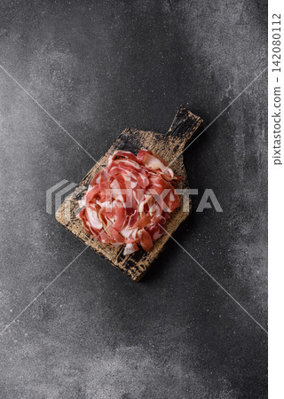 Slices of pork pancetta, ham, or bacon for a festive antipasto platter Slices of pork pancetta, ham, or bacon for a festive antipasto platter 142080112