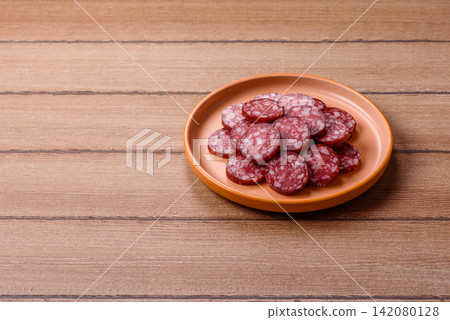 Slices of smoked salami for sandwiches or a lunch spread. Salami slices Slices of smoked salami for sandwiches or a lunch spread. Salami slices 142080128