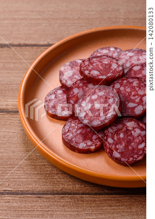 Slices of smoked salami for sandwiches or a lunch spread. Salami slices Slices of smoked salami for sandwiches or a lunch spread. Salami slices 142080133