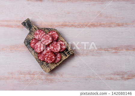 Slices of smoked salami for sandwiches or a lunch spread. Salami slices Slices of smoked salami for sandwiches or a lunch spread. Salami slices 142080146