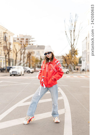 Happy beautiful woman walking and dancing outdoor. Young carefree girl enjoys the day and dancing Happy beautiful woman walking and dancing outdoor. Young carefree girl enjoys the day and dancing 142080683