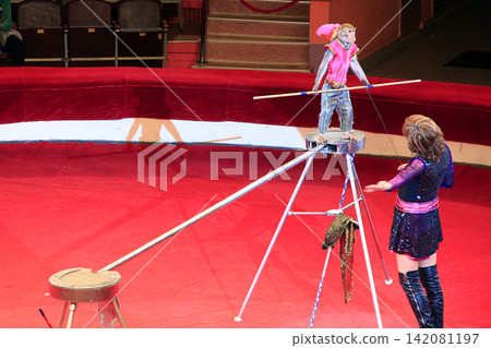 Trained monkey walking on rope with balance beam in Gomel circus Trained monkey walking on rope with balance beam in Gomel circus 142081197