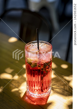Red Cocktail with Ice in an Elegant Glass. Red Cocktail with Ice in an Elegant Glass. 142081652