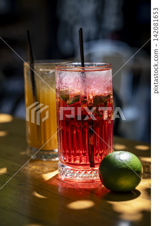 Red Cocktail with Ice in an Elegant Glass. Red Cocktail with Ice in an Elegant Glass. 142081653