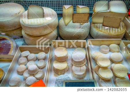 Varieties of cheese at a roofed market in a town on the French Riviera (maybe Cannes) Varieties of cheese at a roofed market in a town on the French Riviera (maybe Cannes) 142082035