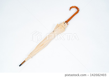 A classic umbrella with an elegant wooden handle. A classic umbrella with an elegant wooden handle. 142082403