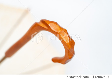 Natural umbrella details with a wooden handle Natural umbrella details with a wooden handle 142082404