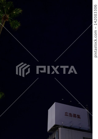 A billboard advertising at night. A white billboard with its lights off. Dark sky and copy space. A billboard advertising at night. A white billboard with its lights off. Dark sky and copy space. 142083306