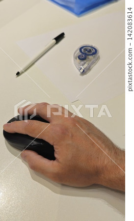 Vertical view Office Desk Setup with Mouse, Pen, and Correction Tape Vertical view Office Desk Setup with Mouse, Pen, and Correction Tape 142083614