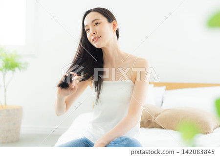 A woman relaxing in the bedroom A woman relaxing in the bedroom 142083845