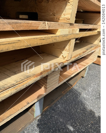 Wooden pallets stored stacked outdoors Wooden pallets stored stacked outdoors 142084013