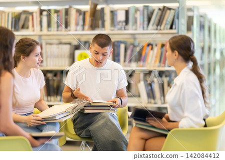 Students sit in circle in library Students sit in circle in library 142084412