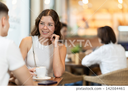 Couple of men and women talking and drinking coffee Couple of men and women talking and drinking coffee 142084461