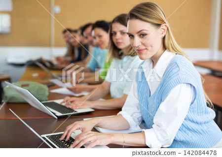 Side view of group of adult students in university classroom Side view of group of adult students in university classroom 142084478