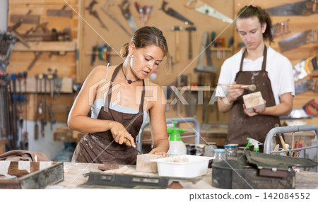 Guy is busy in carpentry workshop with female entrepreneur Guy is busy in carpentry workshop with female entrepreneur 142084552