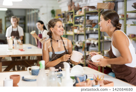 Girl performs polishing of ceramic product Girl performs polishing of ceramic product 142084680