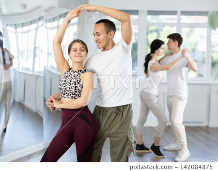 Couples of young men and women dancing waltz Couples of young men and women dancing waltz 142084875