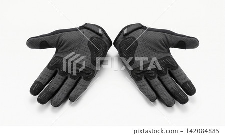 Pair of dark grey cycling gloves with padded palms isolated protection accessory clothing breathable ergonomic recreation exercise stitching isolated background Pair of dark grey cycling gloves with padded palms isolated protection accessory clothing breathable ergonomic recreation exercise stitching isolated background 142084885