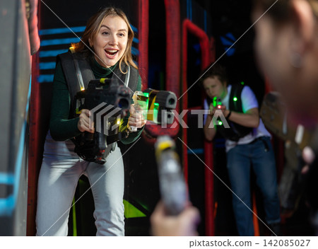 Young woman playing lasertag in arena 142085027