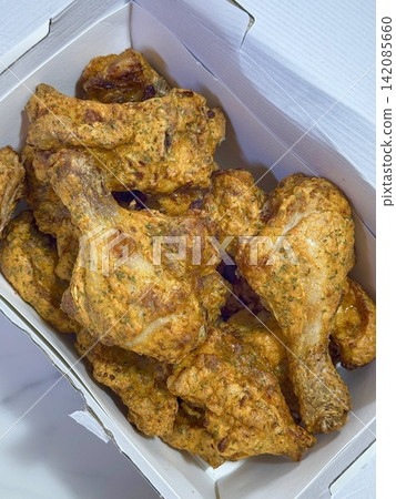 Crispy Korean fried chicken, perfectly glazed with a sweet and spicy sauce. Ideal for food photography and menus, showcasing the irresistible crunch and flavor of this beloved dish. Crispy Korean fried chicken, perfectly glazed with a sweet and spicy sauce. Ideal for food photography and menus, showcasing the irresistible crunch and flavor of this beloved dish. 142085660
