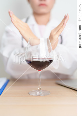Doctor hand stop to refuse Wine, quitting drink for healthy liver, prevent Alcoholic cirrhosis and cancer, World No Alcohol Day, medical advice for sobriety and Alcoholism and addiction concept Doctor hand stop to refuse Wine, quitting drink for healthy liver, prevent Alcoholic cirrhosis and cancer, World No Alcohol Day, medical advice for sobriety and Alcoholism and addiction concept 142087029