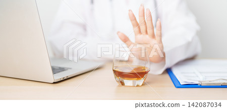 Doctor hand stop to refuse Whisky, quitting drink for healthy liver, prevent Alcoholic cirrhosis and cancer, World No Alcohol Day, medical advice for sobriety and Alcoholism and addiction concept Doctor hand stop to refuse Whisky, quitting drink for healthy liver, prevent Alcoholic cirrhosis and cancer, World No Alcohol Day, medical advice for sobriety and Alcoholism and addiction concept 142087034