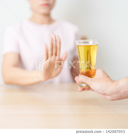 woman making stop hand gesture to refuse a glass of Beer, Healthy man say no to alcohol drink, stop alcoholism and addiction concept. Responsible man reject a drink before driving and quit booze woman making stop hand gesture to refuse a glass of Beer, Healthy man say no to alcohol drink, stop alcoholism and addiction concept. Responsible man reject a drink before driving and quit booze 142087053