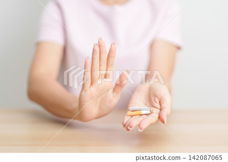 woman hand break cigarette for World No Tobacco Day concept, quitting smoking to prevent Lung Cancer, COPD, Emphysema and Tuberculosis disease. healthy lifestyle resolution, stop nicotine addiction woman hand break cigarette for World No Tobacco Day concept, quitting smoking to prevent Lung Cancer, COPD, Emphysema and Tuberculosis disease. healthy lifestyle resolution, stop nicotine addiction 142087065