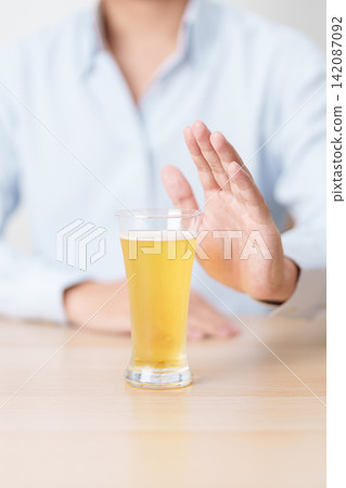man making stop hand gesture to refuse a glass of Beer, Healthy man say no to alcohol drink, stop alcoholism and addiction concept. Responsible man reject a drink before driving and quit booze man making stop hand gesture to refuse a glass of Beer, Healthy man say no to alcohol drink, stop alcoholism and addiction concept. Responsible man reject a drink before driving and quit booze 142087092