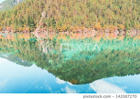 Scenery Jiuzhaigou national park in Sichuan, China. Beautiful of Mirror Lake in Autumn season. Famous Landmark and Vacation near Chengdu, China. Asia travel concept Scenery Jiuzhaigou national park in Sichuan, China. Beautiful of Mirror Lake in Autumn season. Famous Landmark and Vacation near Chengdu, China. Asia travel concept 142087270