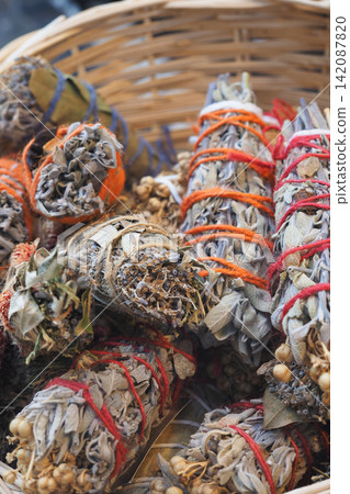 Bundles of herbs placed in a woven basket Bundles of herbs placed in a woven basket 142087820
