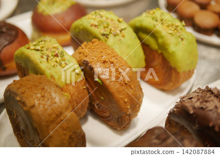 Fresh pastries on display in a bakery Fresh pastries on display in a bakery 142087884