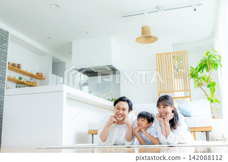 A family relaxing in the living room A family relaxing in the living room 142088112